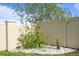 Charming garden area with stone statue, flowering bushes, and white stone ground cover by a fence at 4054 Silverstream Ter, Sanford, FL 32771