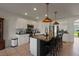 Bright kitchen featuring island with bar seating, white cabinets, and stainless appliances at 4054 Silverstream Ter, Sanford, FL 32771