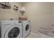 Bright laundry room featuring an LG washer and dryer set with storage shelves and baskets at 4054 Silverstream Ter, Sanford, FL 32771