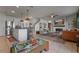 Open concept living room with tile floors, a fireplace, and a breakfast bar for entertaining guests at 4054 Silverstream Ter, Sanford, FL 32771