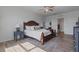 Spacious primary bedroom with hardwood flooring and a king bed, and side tables with decorative lamps at 4054 Silverstream Ter, Sanford, FL 32771