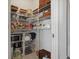 Walk-in pantry with abundant shelving for optimized kitchen storage at 4054 Silverstream Ter, Sanford, FL 32771