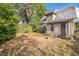 View of house backyard surrounded by mature trees and greenery, creating a serene setting at 419 Palm Ave, Eustis, FL 32726
