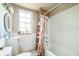 Bright bathroom featuring a bathtub with a shower, toilet, vanity, and a window for natural light at 419 Palm Ave, Eustis, FL 32726