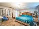Spacious bedroom with artwork, plush carpet, and plenty of natural light at 419 Palm Ave, Eustis, FL 32726