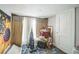 Small bedroom area that features random items and a sunflower tapestry at 419 Palm Ave, Eustis, FL 32726