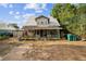 Charming two-story home with a metal roof and covered front porch at 419 Palm Ave, Eustis, FL 32726