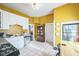 Kitchen featuring white cabinets, stainless steel appliances, and yellow walls at 419 Palm Ave, Eustis, FL 32726