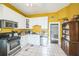 Cozy kitchen features white cabinets, stainless steel appliances, and a checkerboard backsplash at 419 Palm Ave, Eustis, FL 32726