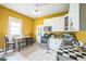 Bright kitchen featuring white cabinets, stainless steel appliances and a dining nook at 419 Palm Ave, Eustis, FL 32726