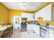 Bright kitchen featuring white cabinets, stainless steel appliances and a dining nook at 419 Palm Ave, Eustis, FL 32726