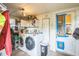 Functional laundry room with a washer, dryer, storage shelves, and access to the exterior at 419 Palm Ave, Eustis, FL 32726