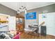 View of living room that looks into the kitchen with hardwood floors and basketball hoop at 419 Palm Ave, Eustis, FL 32726