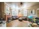 Inviting living room features a brick fireplace and gleaming hardwood floors at 419 Palm Ave, Eustis, FL 32726