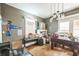 Spacious living room featuring a foosball table, hard wood floors, and a quirky chandelier at 419 Palm Ave, Eustis, FL 32726