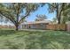 Large backyard, exterior view of a house with mature trees at 4201 Chantelle Rd, Orlando, FL 32808