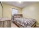 Cozy bedroom with rustic wood-look accents, natural light, and decorative curtains at 4201 Chantelle Rd, Orlando, FL 32808