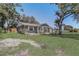 Inviting single-story home with lush front lawn, mature trees, and a welcoming entrance at 4201 Chantelle Rd, Orlando, FL 32808