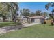 Charming single-story home featuring a well-manicured lawn, paved driveway, and attached single-car garage at 4201 Chantelle Rd, Orlando, FL 32808