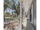 Inviting front porch view with white columns, beautiful trees, and a well-maintained lawn at 4201 Chantelle Rd, Orlando, FL 32808