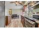 Well-designed kitchen showcasing stainless steel appliances, warm cabinetry, and views to the dining area at 4201 Chantelle Rd, Orlando, FL 32808