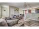 Comfortable living room with stylish wood-look flooring, modern furniture, and views to the kitchen and dining area at 4201 Chantelle Rd, Orlando, FL 32808