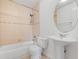 Bathroom with a single sink, and vanity with a matching toilet and tiled shower and bath at 445 Cottonwood Dr, Altamonte Springs, FL 32714