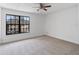 Well-lit bedroom with neutral carpet and a large window, offering a view of the surrounding neighborhood at 445 Cottonwood Dr, Altamonte Springs, FL 32714