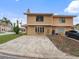 Two-story home with a large driveway and manicured lawn, ideal for comfortable living at 445 Cottonwood Dr, Altamonte Springs, FL 32714