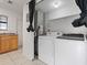 Laundry room features a modern washing machine, dryer, cabinets, and sink with countertop at 445 Cottonwood Dr, Altamonte Springs, FL 32714