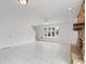 Spacious living room with neutral walls, tile floors, and a stone fireplace creates a warm and inviting ambiance at 445 Cottonwood Dr, Altamonte Springs, FL 32714