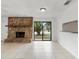 Open living space with a stone fireplace, tile floors, and sliding glass doors for seamless indoor-outdoor living at 445 Cottonwood Dr, Altamonte Springs, FL 32714