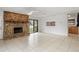 Bright living room with stone fireplace, sliding glass doors, and view to the kitchen through an opening at 445 Cottonwood Dr, Altamonte Springs, FL 32714