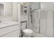 Well-maintained bathroom featuring a vanity, toilet, and glass-enclosed shower at 4459 Bluff Oak Loop, Kissimmee, FL 34746