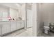 Bright bathroom with double sinks, white cabinetry and a separate toilet room at 4459 Bluff Oak Loop, Kissimmee, FL 34746