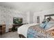 Stylish bedroom featuring an accent wall, comfortable bed, and modern decor at 4459 Bluff Oak Loop, Kissimmee, FL 34746
