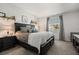 Cozy bedroom with a large bed, soft lighting, and a view from the window at 4459 Bluff Oak Loop, Kissimmee, FL 34746