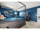 A cozy bedroom offers a comfortable bed, a large window, and modern furniture at 4459 Bluff Oak Loop, Kissimmee, FL 34746