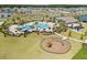 Community pool with splash pad, seating, and playground at 4459 Bluff Oak Loop, Kissimmee, FL 34746