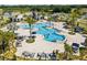 Aerial view of community pool surrounded by lounge chairs and palm trees at 4459 Bluff Oak Loop, Kissimmee, FL 34746