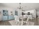 This dining room offers a seamless flow to a kitchen with an eat-in island and modern white cabinets at 4459 Bluff Oak Loop, Kissimmee, FL 34746