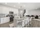 Bright kitchen features an island with seating, stainless appliances, and an open view to the living room at 4459 Bluff Oak Loop, Kissimmee, FL 34746