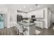 Bright, modern kitchen features an island with seating and stainless steel appliances at 4459 Bluff Oak Loop, Kissimmee, FL 34746