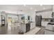 Modern kitchen with a center island, stainless steel appliances, and an adjacent dining area at 4459 Bluff Oak Loop, Kissimmee, FL 34746