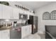 Modern kitchen featuring white cabinets, stainless steel appliances, and stylish decor at 4459 Bluff Oak Loop, Kissimmee, FL 34746