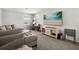 Comfortable living room with plush seating, a large-screen TV, and ample natural light at 4459 Bluff Oak Loop, Kissimmee, FL 34746