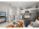 Open-concept living space with a modern kitchen and comfortable seating area at 4459 Bluff Oak Loop, Kissimmee, FL 34746