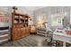 Charming home office with a classic wooden bookcase, cozy chair, and a dedicated workspace at 4459 Bluff Oak Loop, Kissimmee, FL 34746