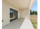 Outdoor patio with a sliding glass door, offering a relaxing space with views of the yard at 4459 Bluff Oak Loop, Kissimmee, FL 34746