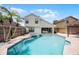 Fantastic backyard pool and spa with palm trees and the house exterior on a sunny day at 479 Cidermill Place, Lake Mary, FL 32746